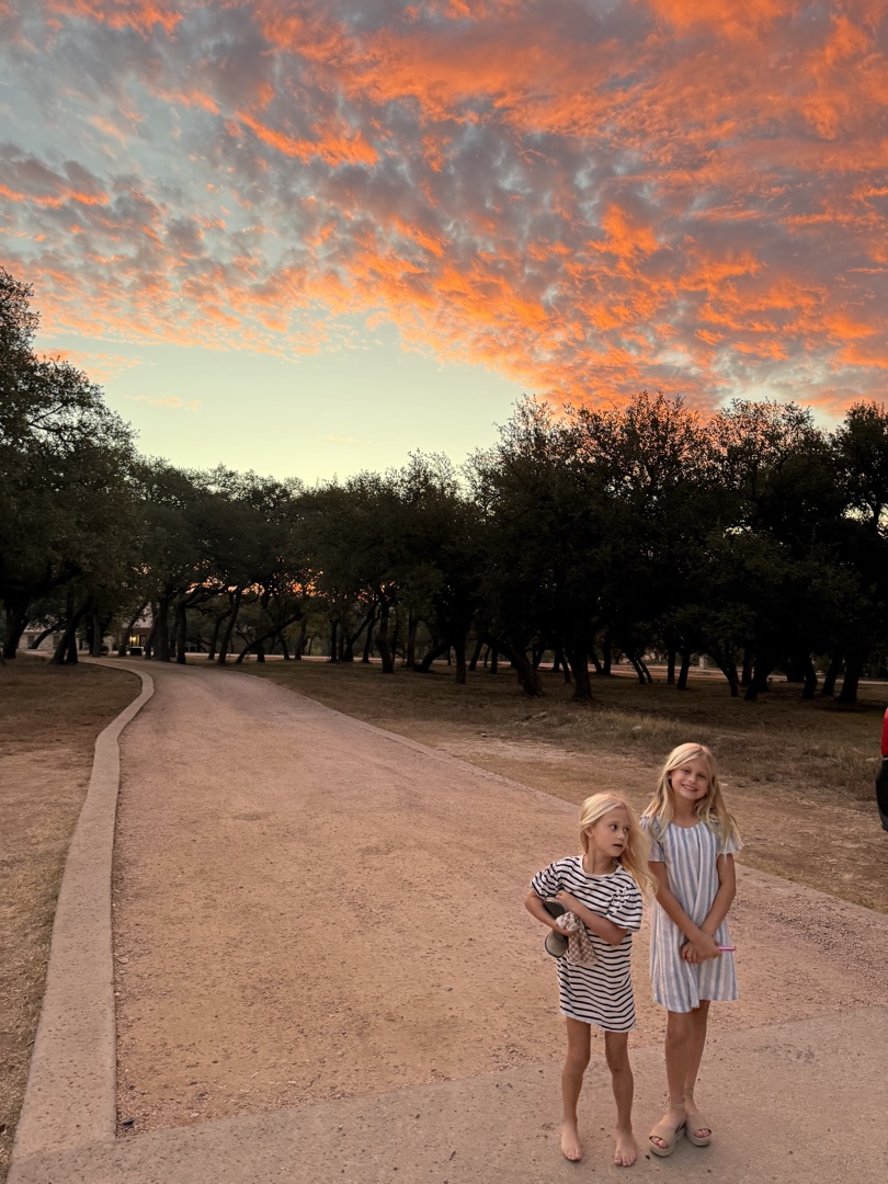 Two girls on a Hill Country road at golden hour in Dripping Springs
